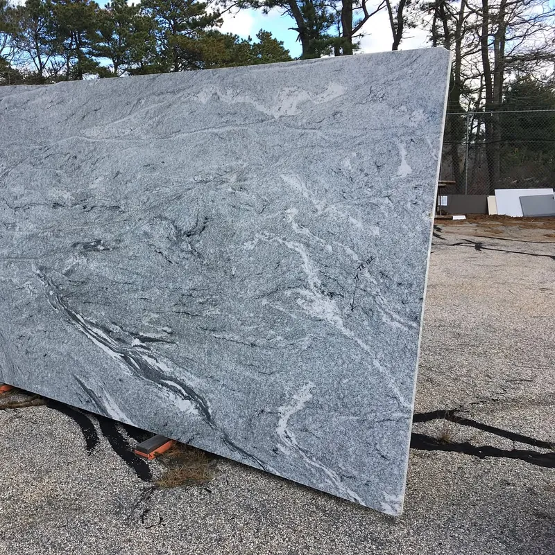 Gray stone slab with flowing white movement standing in the yard at 18 Fruean Way