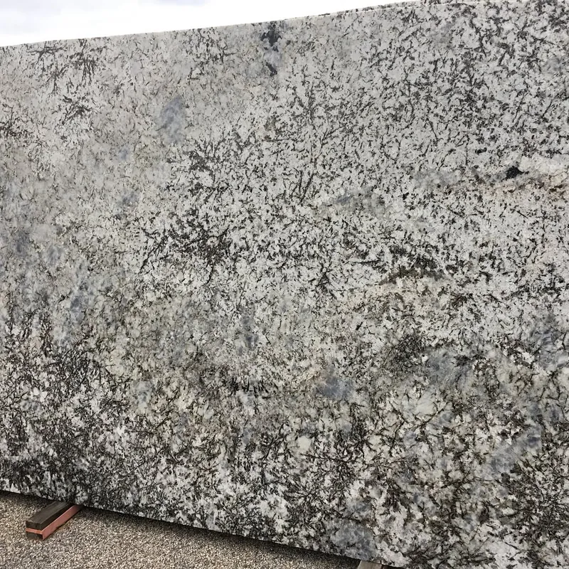 White slab with dense black-and-gray mineral clusters in the yard at 18 Fruean Way