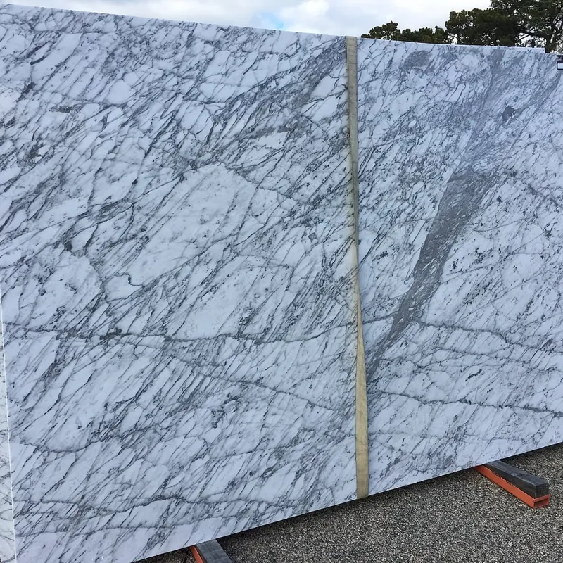 White slab with a net of gray veins standing in the yard at 18 Fruean Way