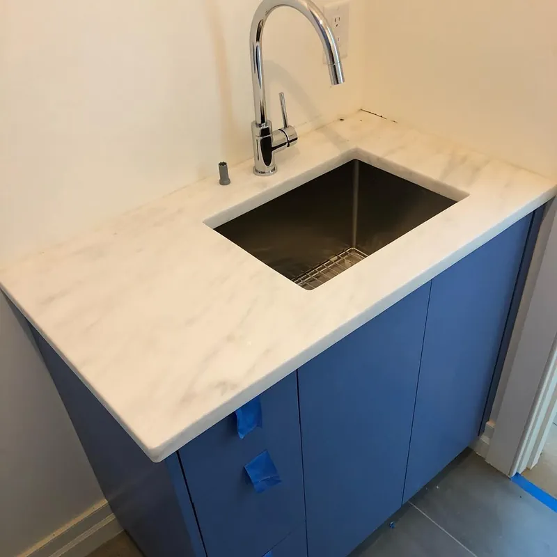 White Rhino vanity top with a square undermount sink on a blue cabinet, Chatham, MA