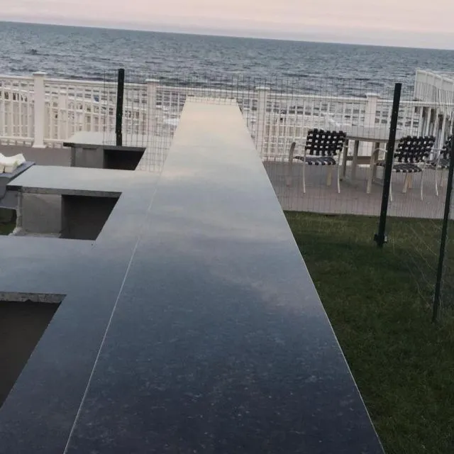 Stone bar countertop overlooking the water — one of our Cape Cod installations